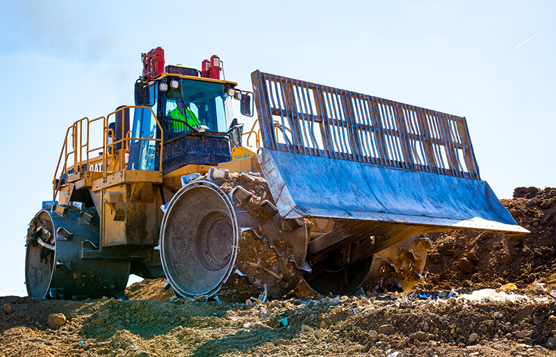 Picture of a large bulldozer used by Champ Landfill in their daily operation.